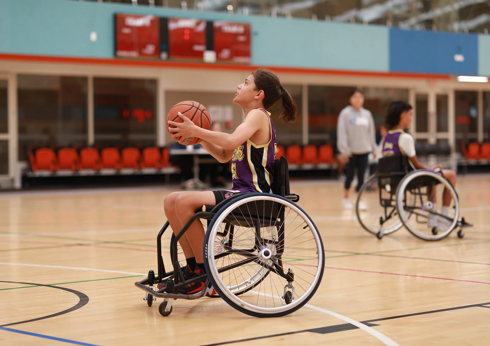 Young māori boy in a wheelchair playing basketball